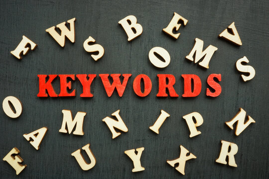A Word keywords and wooden letters around.