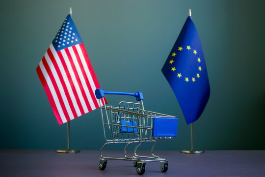 USA and EU flags and a shopping cart as a symbol of trade relations.
