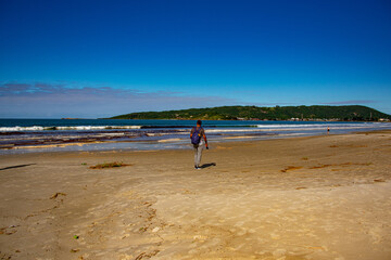 person walking on the beach in Florianópolis