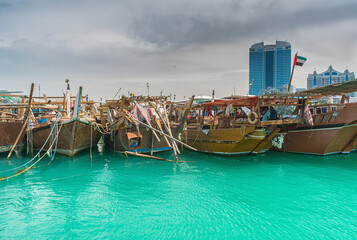 Fototapeta na wymiar Traditional Dhows mooring at Al Mina port in Abu Dhabi, United Arab Emirates