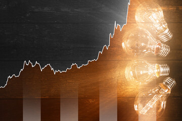 Light bulbs and rising chart representing current electricity price during energy crisis in the...