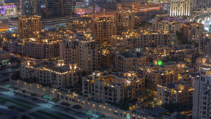 Aerial view to traditional houses of old town island night timelapse from above.