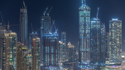 Fototapeta na wymiar Futuristic aerial night cityscape timelapse with illuminated architecture of Dubai downtown, United Arab Emirates.