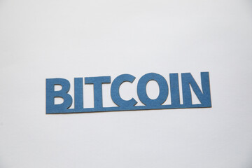 Paper inscriptions of cryptocurrencies on a white background