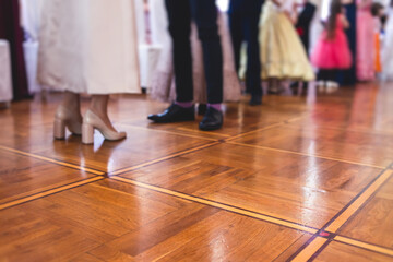 Fototapeta na wymiar Couples dance on the historical costumed ball in historical dresses, classical ballroom dancers dancing, waltz, quadrille and polonaise in palace interiors on a wooden floor, charity event