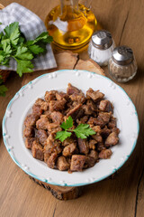 Muslims Traditional Sacrifice holiday food lamb, Turkish roasted meat in copper pot on table top. Turkish Kavurma. (Turkish name; Kurban kavurma)