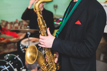 Concert view of saxophonist, saxophone sax player with vocalist and musical during jazz orchestra performing music on stage - obrazy, fototapety, plakaty