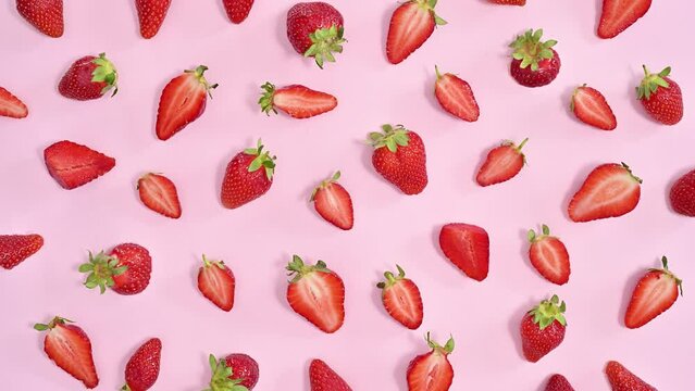 Creative healthy food pattern with sweet organic strawberries on pastel pink background. Stop motion flat lay