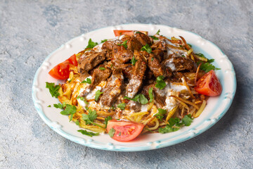 Turkish food; Cokertme Kebab - Beef meat kebab with yoghurt and french fries