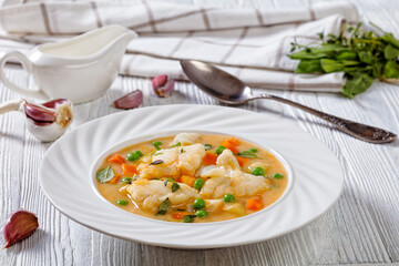 white fish chowder with green peas, potatoes