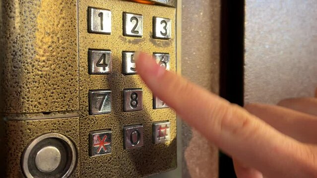 The code set in the intercom is close-up. Opening the door in the entrance with a password. Security system with manual entry of the security access code at the entrance.