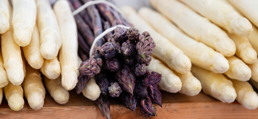 Close up of purple and white asparagus at weekly market