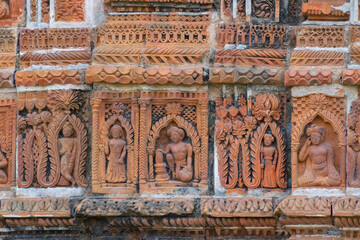 Terracotta decorations on the walls at Pratapeswar Temple at Kalna, West Bengal, India. Terracotta is a brownish-red clay that has been baked and is used for making things.