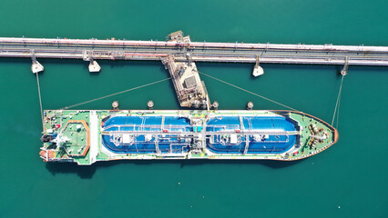 Aerial drone top view photo of industrial LNG gas container tanker anchored in Mediterranean port