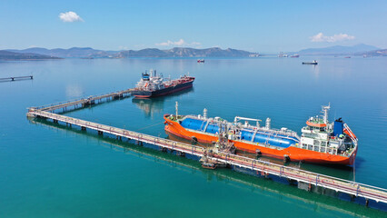 Fototapeta Aerial drone top view photo of industrial LNG gas container tanker anchored in Mediterranean port obraz