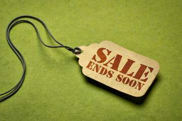 sale ends soon - a paper price tag against green background, marketing and shopping concept