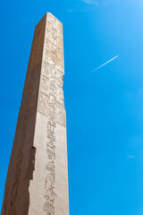 Ancient monument in Karnak Temple, Egypt and departing plane. Egyptian hieroglyphics. 