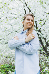 Portrait of beautiful romantic lady in apple trees blossoms