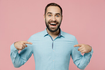 Young exciuted fun surprised exultant jubilant caucasian man in classic blue shirt point index finger on himself isolated on plain pastel light pink background studio portrait People lifestyle concept