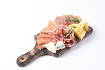 Appetizers table with different antipasti, charcuterie, snacks and cheese. Buffet party. Wooden cutting board isolated on white background, top view