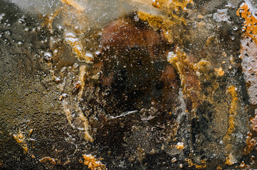 Texture, background, top view of a black tray smeared in fat, after cooking a meat dish. Food photography, abstract.