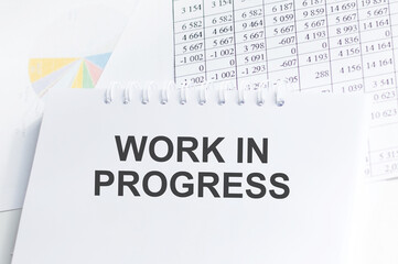 working in progress text on a notepad on an office desk, a business concept