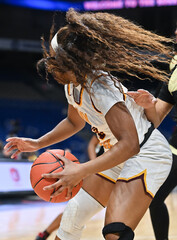 Girl with long hair dribbling the ball in a basketball game