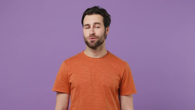 Boring sad pensive young brunet bearded man 20s wears red t-shirt looking around sithe take mobile cell phone gets excited happy cheery isolated on plain pastel light purple background studio portrait