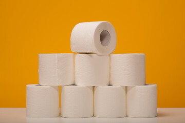 Lots of toilet paper rolls on a yellow background.