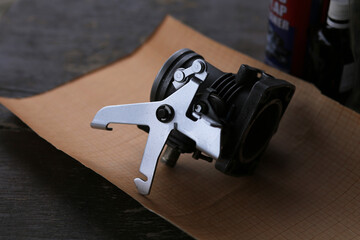 The upper part of the throttle for a petrol car is painted.