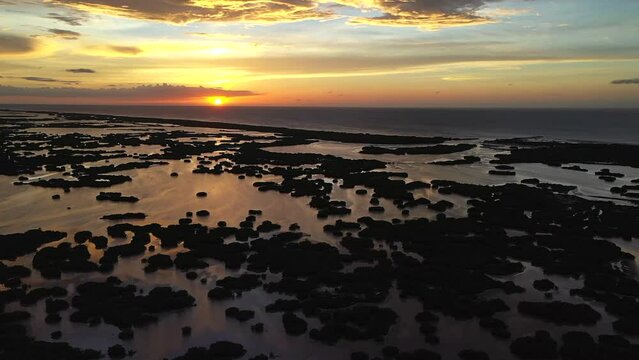 Aerial drone footage of the stunning sunset over an area of mangroves.  Stunning colors of the clouds