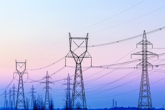 Power Transmission Lines And Towers At Dusk, Near Winnipeg, Manitoba, Canada.