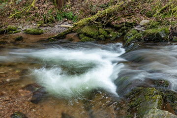 Fototapeta premium Long exposure of a waterfall on the river Horner in Horner woods in Somerset
