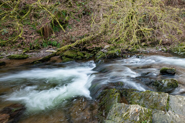 Naklejka na ściany i meble Long exposure of a waterfall on the river Horner in Horner woods in Somerset