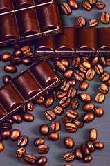 Dark chocolate and coffee beans flat lay. Brown background