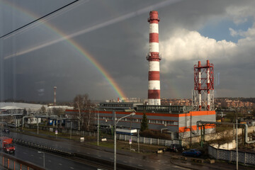Fototapeta na wymiar rainbow after rain over the heating power plant