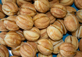 Nuts in the shape of a sweet cookie, nutrition concept. Nuts for baking. Sweet nuts with condensed milk. Sweet pastry in the form of a nut. Homemade cookies.