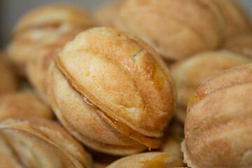 Nuts in the shape of a sweet cookie, nutrition concept. Nuts for baking. Sweet nuts with condensed milk. Sweet pastry in the form of a nut. Homemade cookies.