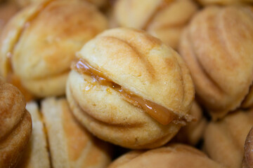 Nuts in the shape of a sweet cookie, nutrition concept. Nuts for baking. Sweet nuts with condensed milk. Sweet pastry in the form of a nut. Homemade cookies.