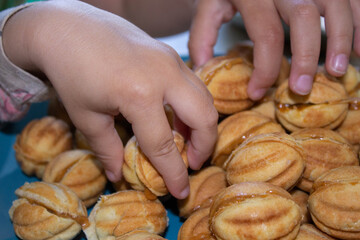 Nuts in the shape of a sweet cookie, nutrition concept. Nuts for baking. Sweet nuts with condensed milk. Sweet pastry in the form of a nut. Homemade cookies.