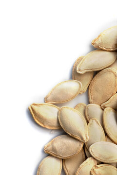 Pumpkin seeds on a white background. Close up