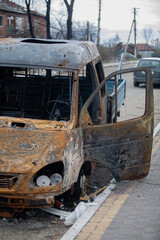 Fototapeta premium Burnt car after shelling by Russian military