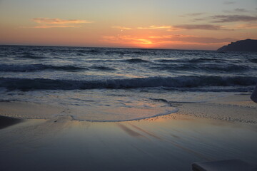 pomarańczowy zachód słońca nad morzem, orange sunset over the sea, sandy beach by the sea at sunset - obrazy, fototapety, plakaty