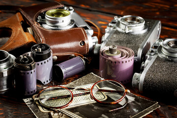 Old vintage photo cameras on an old background.