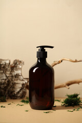 Soap or shampoo pump bottle with bark, tree branch, green moss. SPA natural cosmetic concept.