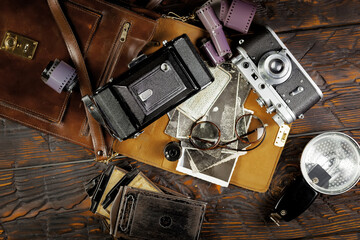 Old vintage photo cameras on an old background.