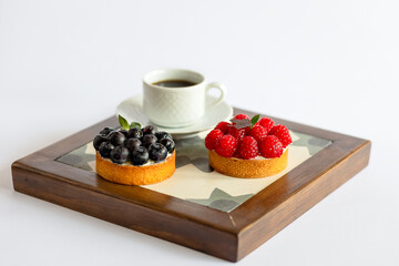 Mix cakes with fresh berries on white background
