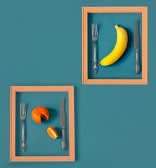 Creative food concept. Fruits in a pink frame on a sea-green surface in pop art style. Tinted, top...