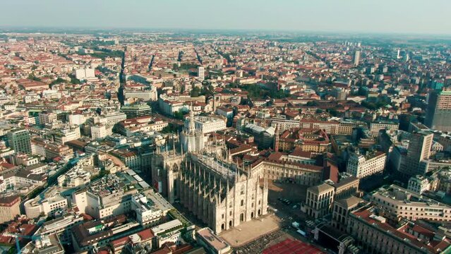 Establishing Aerial shot of cathedral church of Milan, Lombardy, Italy. Drone view above Landmark Metropolitan Basilica of Saint Mary and central cityscape with Downtown. 4K panoramic travel video