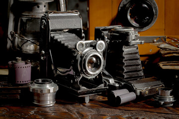 An old camera in a composition on an old background, on a table